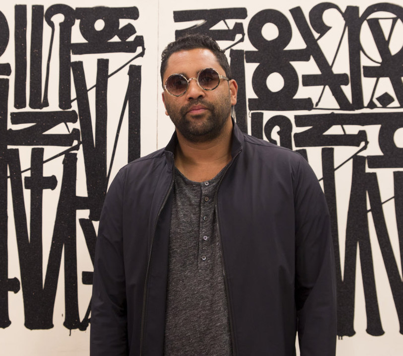 LA-Based Street Artist RETNA with one of his paintings