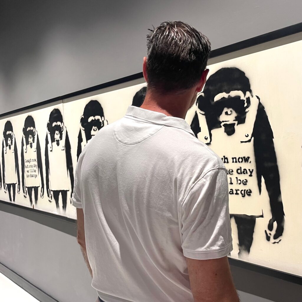 Reed Horth with Banksy "Laugh Now" in The MOCO Museum in Barcelona