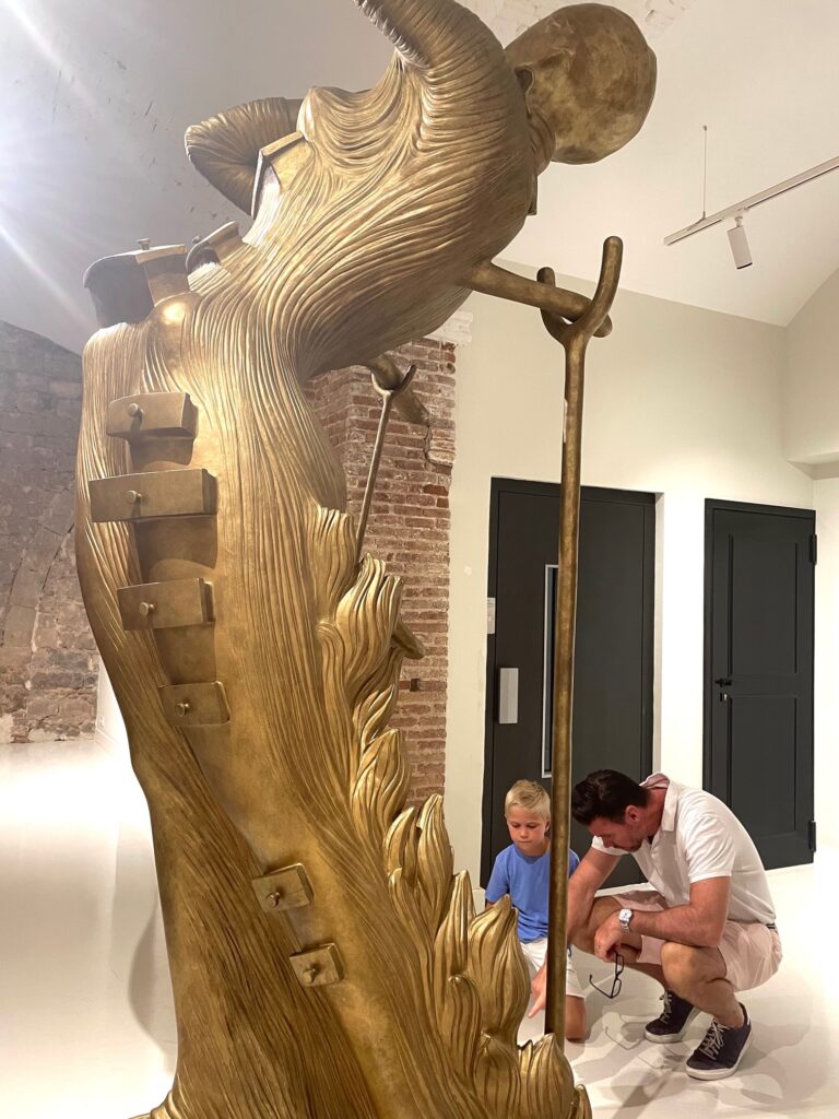 Reed Horth explaining Salvador Dali's monumental-scale "Femme Aflame" bronze his son in The MOCO Museum in Barcelona
